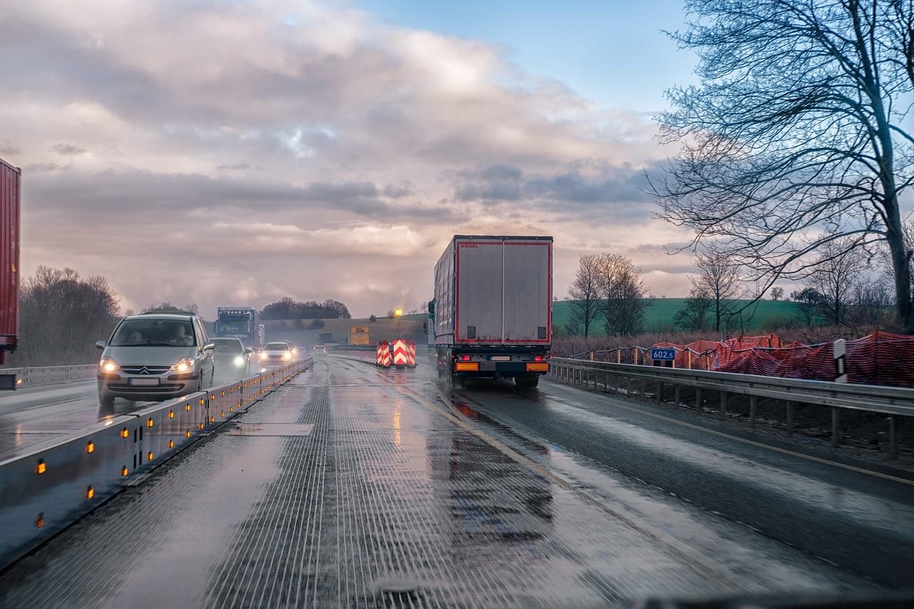 View of an 18-wheeler truck driving on a wet road before a truck accident