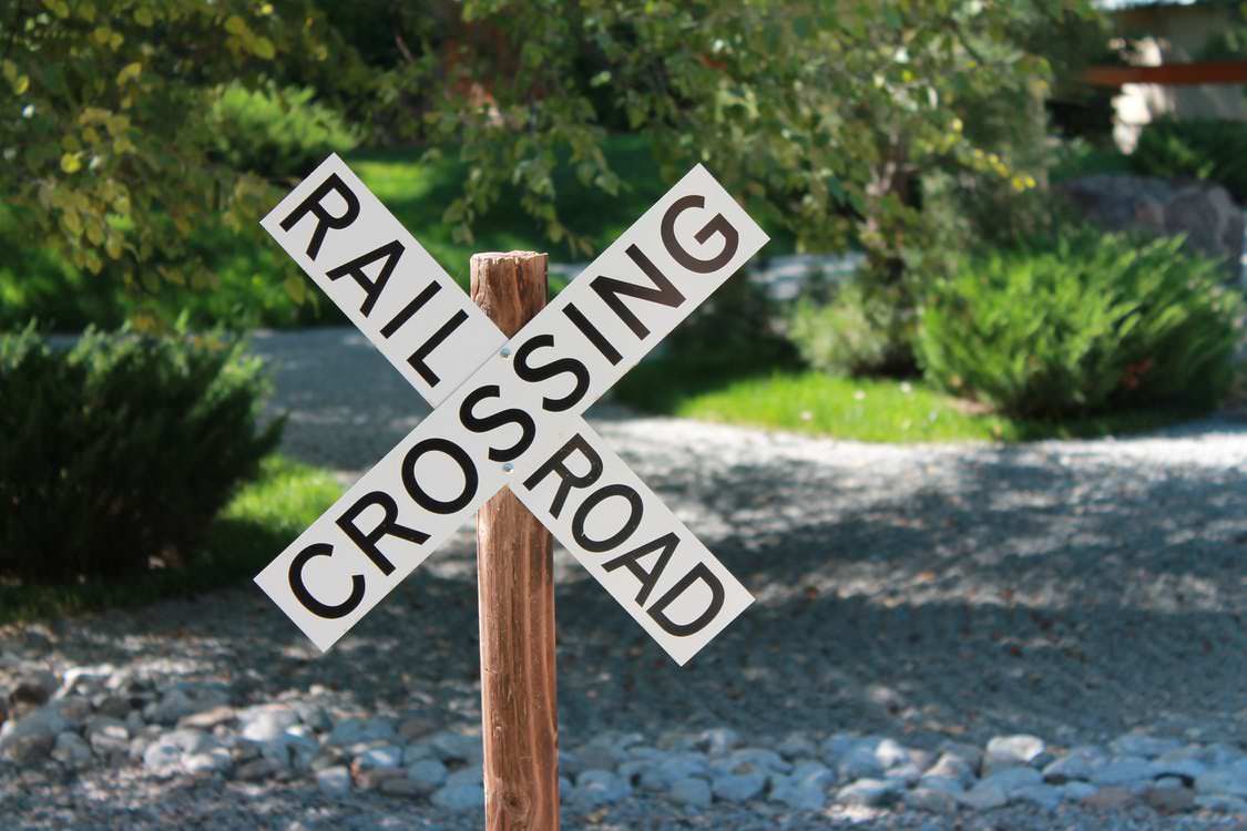 Railroad crossing warning sign warns drivers to help prevent a car accident