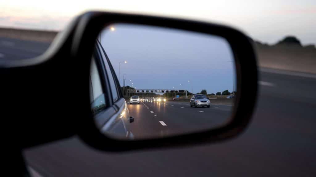 View of traffic from side mirror before a car accident