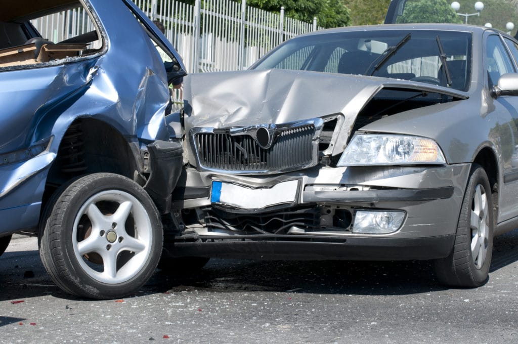 Two vehicles with damage after a crash before calling a car accident lawyer