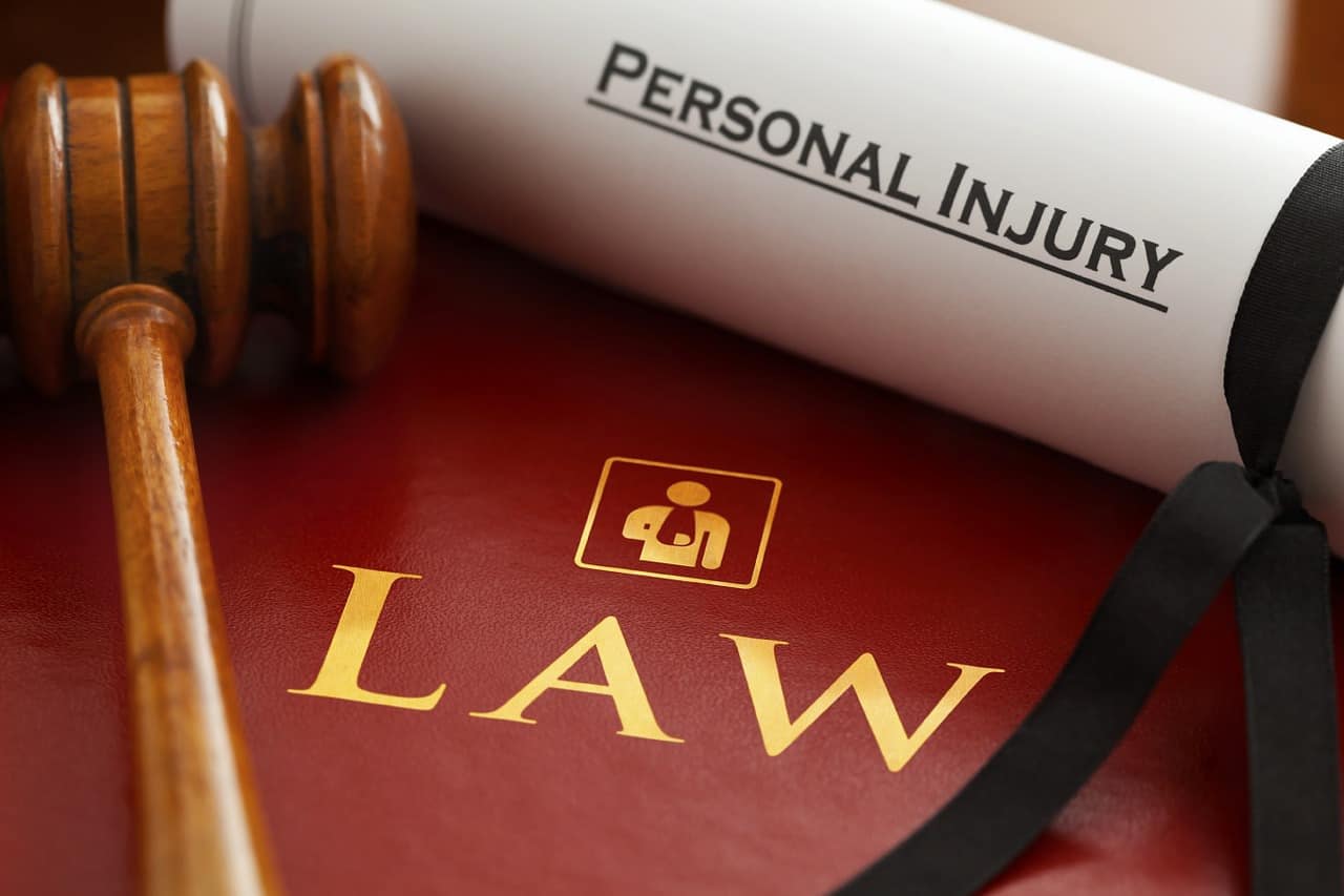 Personal injury law concept with a law book and a gavel