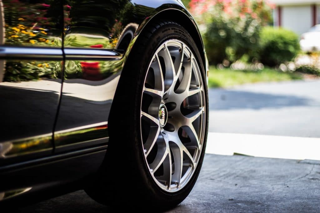 Closeup of the wheels of an expensive car parked in a Miami garage