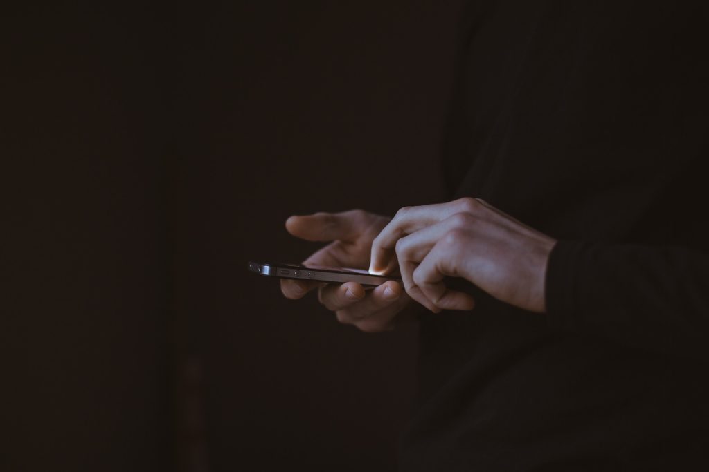 Closeup view of a pair of hands using a smartphone