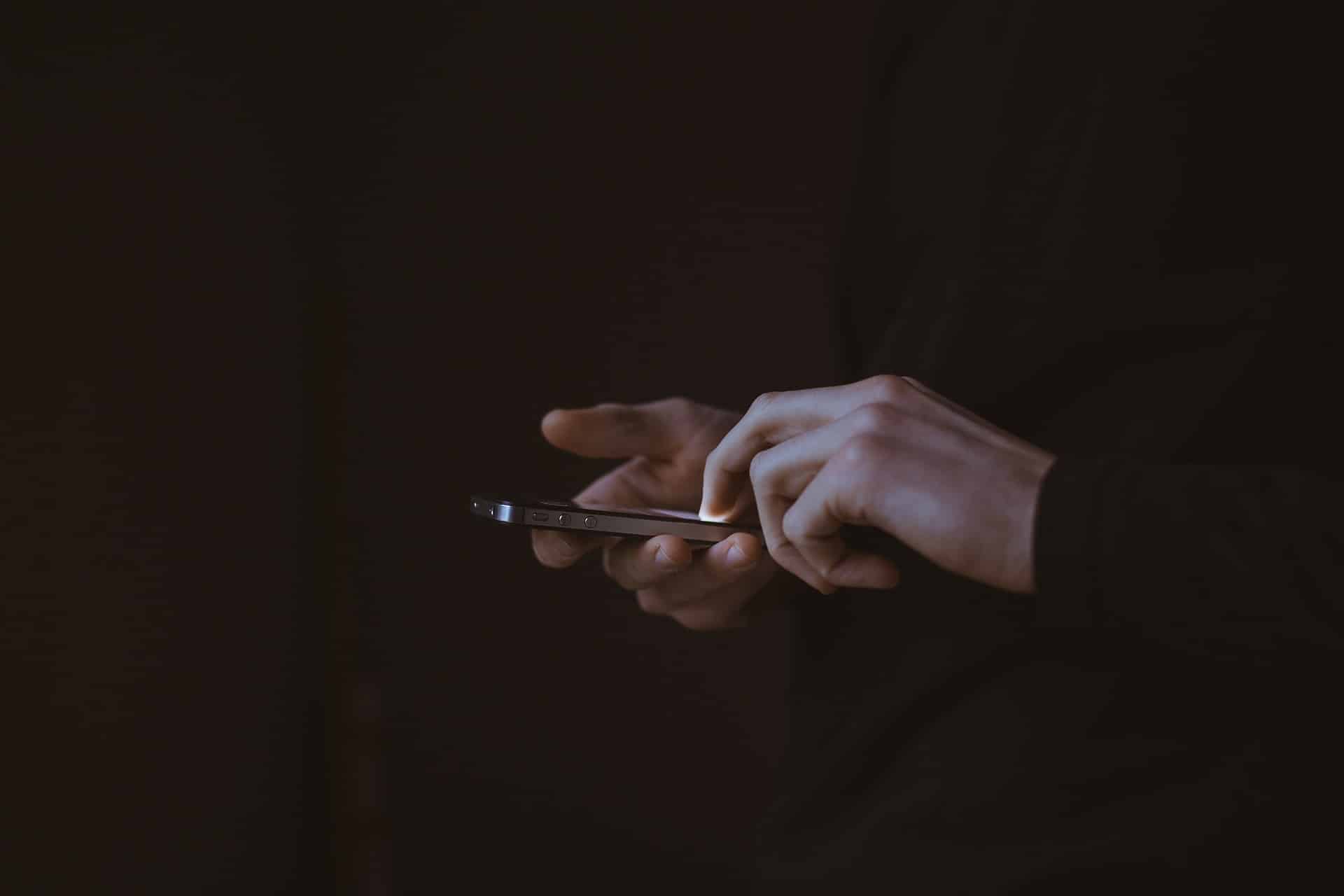 Closeup view of a pair of hands using a smartphone