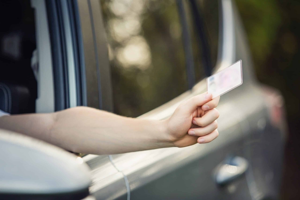 handling a driver's license through car's window