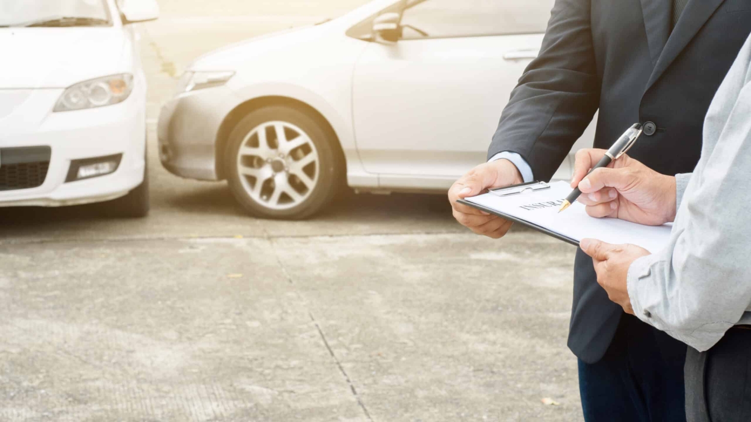 man filling out paperwork after a car accident