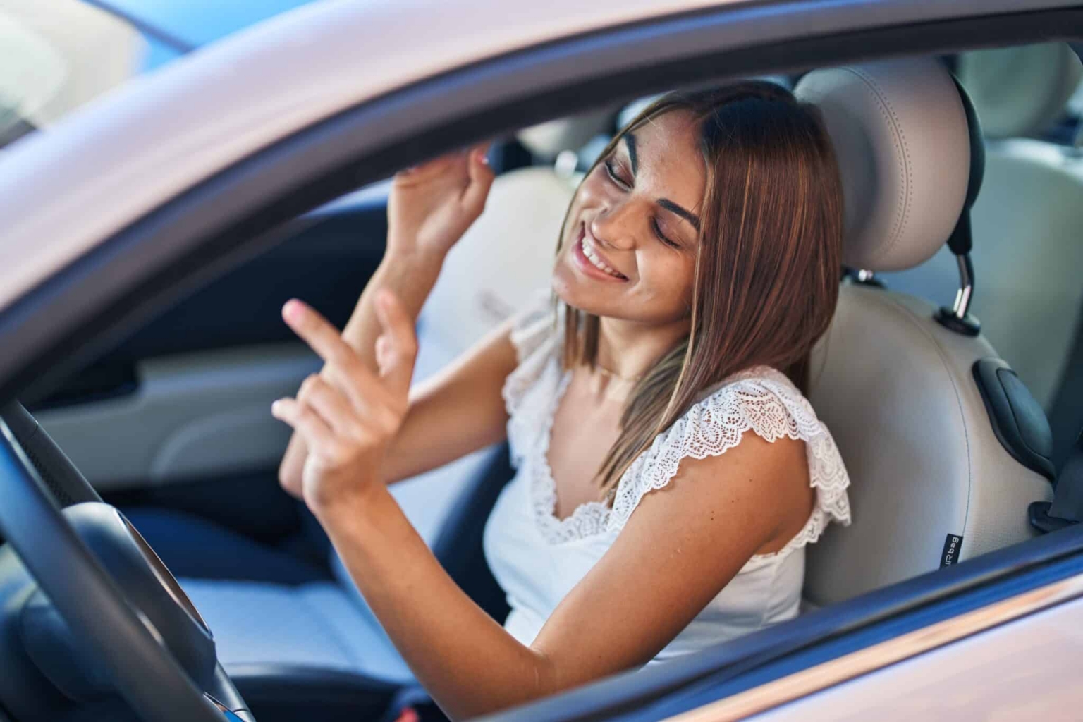 Young,Beautiful,Hispanic,Woman,Sitting,On,Car,Dancing,At,Street