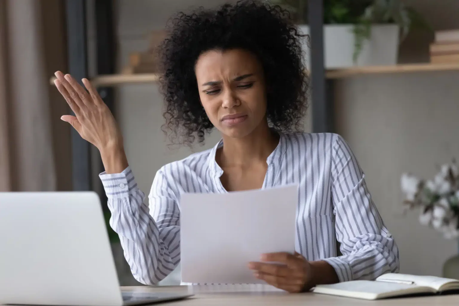 Stressed,Young,African,American,Businesswoman,Looking,At,Paper,Document,In