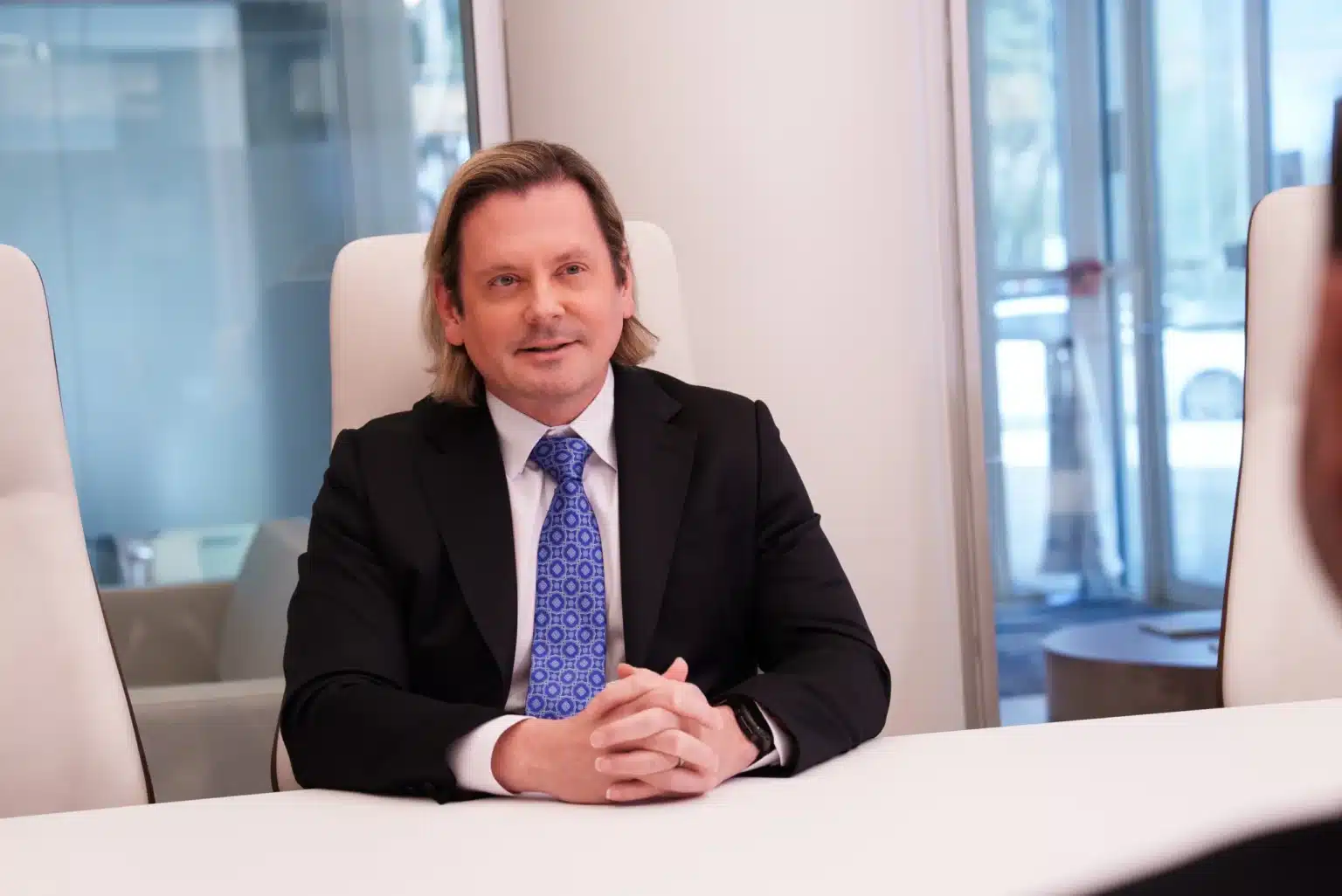 Personal injury lawyer speaking with a client during a consultation in an office.