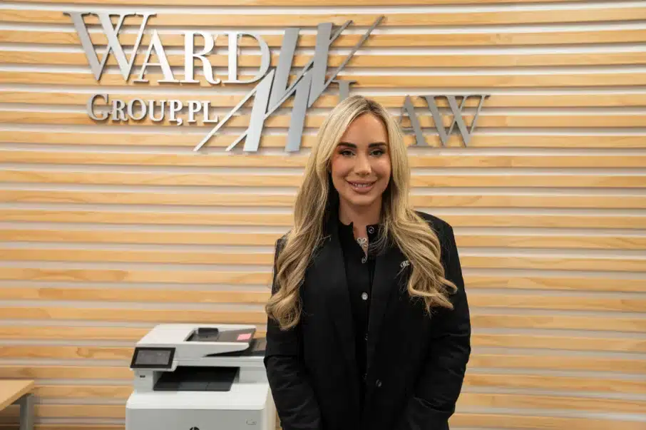 Ward Law attorney standing in front of Ward Law sign in New York City office.